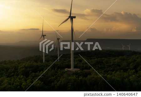 Wind energy. Wind power. Sustainable, renewable energy. Wind turbines generate electricity. Windmill farm on a mountain with sunset sky. Green technology. Renewable resource. Sustainable development. Wind energy. Wind power. Sustainable, renewable energy. Wind turbines generate electricity. Windmill farm on a mountain with sunset sky. Green technology. Renewable resource. Sustainable development. 140640647
