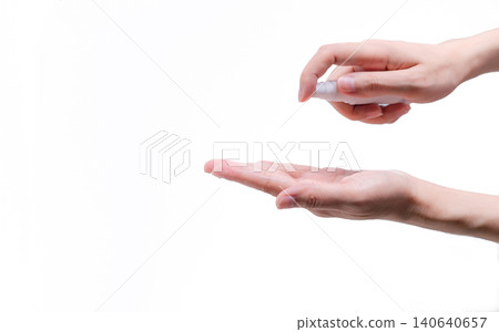 Woman hand hold alcohol bottle and spray on palm to protect and kill coronavirus and cleaning hand. Personal hygiene to prevent coronavirus or flu epidemic. Cleaning hands from germs, virus, bacteria. Woman hand hold alcohol bottle and spray on palm to protect and kill coronavirus and cleaning hand. Personal hygiene to prevent coronavirus or flu epidemic. Cleaning hands from germs, virus, bacteria. 140640657