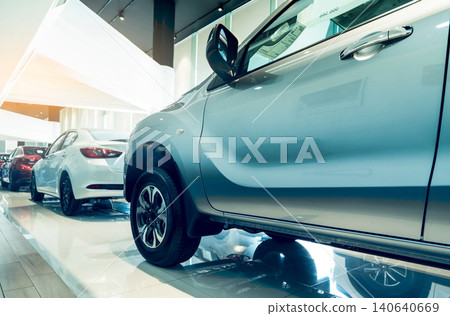 New car parked in modern showroom. Auto leasing and car dealership concept. Red, white, and silver car inventory stock in showroom office for sale. Modern luxury showroom. Electric vehicle business. New car parked in modern showroom. Auto leasing and car dealership concept. Red, white, and silver car inventory stock in showroom office for sale. Modern luxury showroom. Electric vehicle business. 140640669