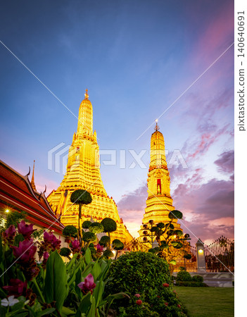 Wat Arun Ratchawararam at sunset. The iconic Buddhist temple, historic architecture and cultural heritage of Bangkok, Thailand. Famous travel landmarks. Thai architecture, spiritual heritage. Wat Arun Ratchawararam at sunset. The iconic Buddhist temple, historic architecture and cultural heritage of Bangkok, Thailand. Famous travel landmarks. Thai architecture, spiritual heritage. 140640691