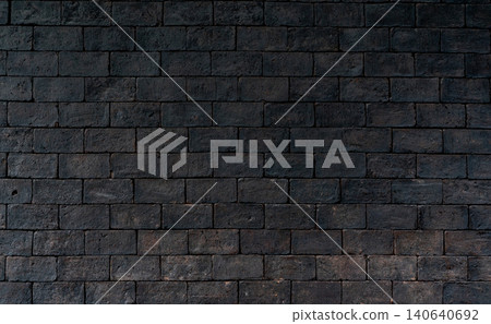 Black and brown rough brick wall texture background with a dark weathered surface, expressing concepts of grief, sadness, hopelessness and emotional despair through dramatic architectural detail. Black and brown rough brick wall texture background with a dark weathered surface, expressing concepts of grief, sadness, hopelessness and emotional despair through dramatic architectural detail. 140640692