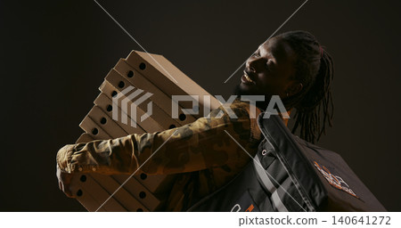 Takeout courier delivering huge pizza order on camera, carrying big stack of cardboard boxes as fast food meal, African American deliveryman bringing takeaway food, stylish trendy man. 140641272