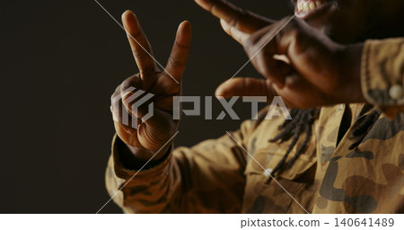 Male model showing heart shape sign on camera, presenting his love and sincere feelings, young adult smiling and doing romantic symbol, being flirty and sweet, handheld shot, close up. Male model showing heart shape sign on camera, presenting his love and sincere feelings, young adult smiling and doing romantic symbol, being flirty and sweet, handheld shot, close up. 140641489
