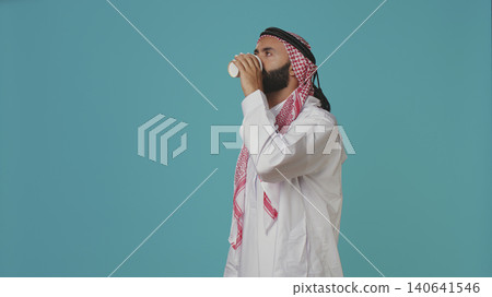 Muslim adult serving coffee cup in the morning, enjoying refreshment drink with caffeine and energy. Muslim adult serving coffee cup in the morning, enjoying refreshment drink with caffeine and energy. 140641546