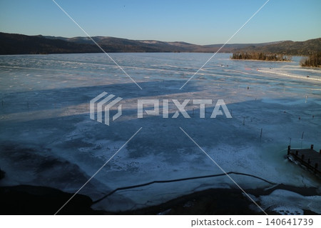Aerial view of Lake Akan at sunset, frozen over. Aerial view of Lake Akan at sunset, frozen over. 140641739