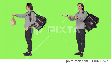 Posing over green screen studio backdrop, person working on delivering food with thermal backpack, with young adult carrying huge bag for delivery service, eager to provide good service. Posing over green screen studio backdrop, person working on delivering food with thermal backpack, with young adult carrying huge bag for delivery service, eager to provide good service. 140641824