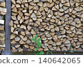 Firewood stacked on shelves 140642065