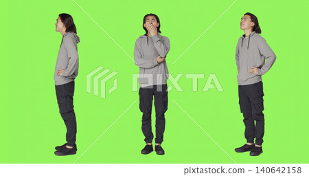 Young man feeling sleepy and yawning after not getting enough sleep, posing with fatigue over full body green screen backdrop, with person being extremely tired and exhausted, falling asleep. Young man feeling sleepy and yawning after not getting enough sleep, posing with fatigue over full body green screen backdrop, with person being extremely tired and exhausted, falling asleep. 140642158