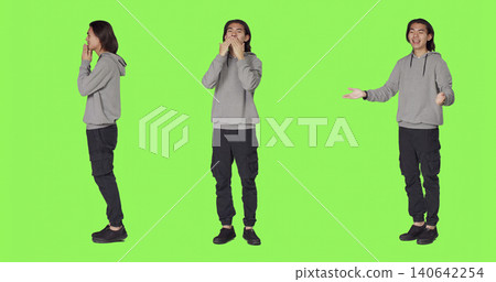 Man sending air kisses on camera, acting flirty and cute standing against green screen background, with young adult feeling confident and romantic showing true sweet emotions. Man sending air kisses on camera, acting flirty and cute standing against green screen background, with young adult feeling confident and romantic showing true sweet emotions. 140642254