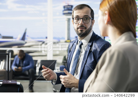 Business trip, formal wear passengers, airport terminal lounge, waiting for departure, international flight for work trip. Multiethnic people traveling in busy airport waiting area. Business trip, formal wear passengers, airport terminal lounge, waiting for departure, international flight for work trip. Multiethnic people traveling in busy airport waiting area. 140642299