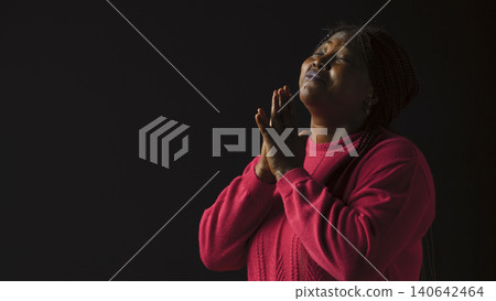 Graceful woman gazing upwards with palms extended in gesture of reverance and adoration. Graceful woman gazing upwards with palms extended in gesture of reverance and adoration. 140642464