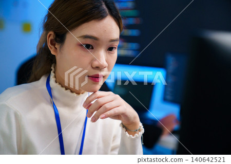Focused software developer at workstation in modern tech office Focused software developer at workstation in modern tech office 140642521