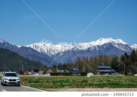 長野縣安曇野市北阿爾卑斯山全景公路的列車員行進場景。 長野縣安曇野市北阿爾卑斯山全景公路的列車員行進場景。 140642723
