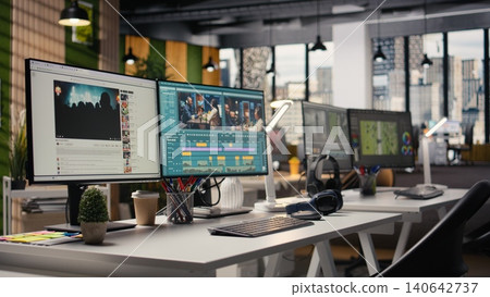 No people in office, video editing software, streaming platform, on dual monitors, creative agency working on cutting footage and montage for filmmaking post production. Creative process. 140642737