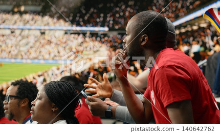 Tense sports fans checking online betting odds and cash out options on smartphone, live football match in the stadium stands. Passionate supporters tracking risky wagers on betting apps. 140642762