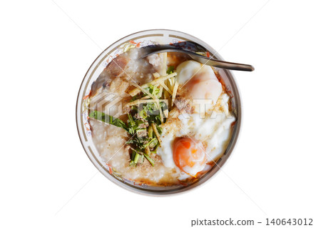 Homemade Asian rice porridge served with soft boiled eggs isolated. Homemade Asian rice porridge served with soft boiled eggs isolated. 140643012