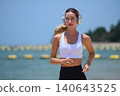 Active lifestyle concept: Woman jogging outdoors while listening to music 140643525