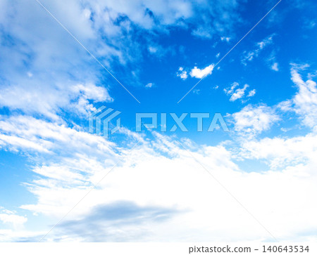 A simple yet dramatic landscape of blue sky and white clouds. 140643534