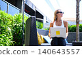 Digital nomad woman working on laptop at an outdoor resort lounge 140643557