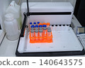 Laboratory Centrifuge Tubes on Orange Rack Inside Scientific Incubator Equipment for Biological Research 140643575