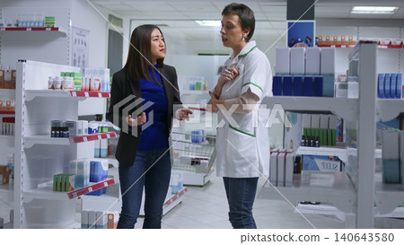 Client feeling unwell visiting pharmacy, looking to find pharmaceutical product to cure nauseating headache. Client feeling unwell visiting pharmacy, looking to find pharmaceutical product to cure nauseating headache. 140643580