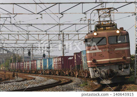 A container freight train pulled by an EF81 locomotive. A container freight train pulled by an EF81 locomotive. 140643915
