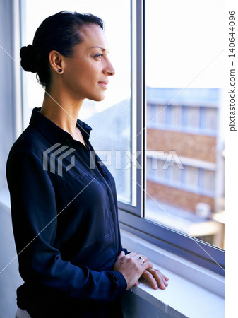 Reflection, thinking and woman at window in office with business idea, opportunity and career. Vision, memory and businesswoman planning future growth, ambition and inspiration for job development. Reflection, thinking and woman at window in office with business idea, opportunity and career. Vision, memory and businesswoman planning future growth, ambition and inspiration for job development. 140644096