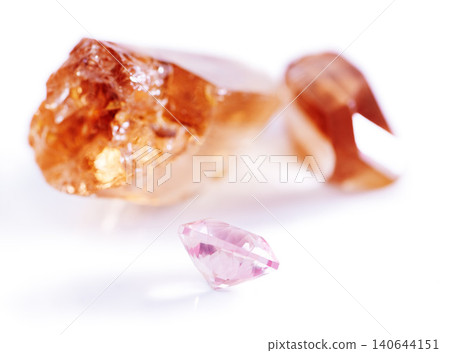Gemstone, citrine and pink diamond in studio with isolated white background for natural resource, jewel and sparkle for luxury. Rock, crystal and reflection in closeup for shine, glow and mineral Gemstone, citrine and pink diamond in studio with isolated white background for natural resource, jewel and sparkle for luxury. Rock, crystal and reflection in closeup for shine, glow and mineral 140644151
