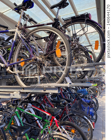 Crowded public bicycle parking garage under a canopy Crowded public bicycle parking garage under a canopy 140644170