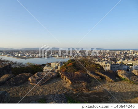 A panoramic view of Lake Nakaumi, the Sea of Japan, and the city of Yonago from the stone foundation of the castle tower at Yonago Castle ruins in Tottori Prefecture. 140644246