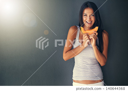 Slice of melon, portrait and hungry with woman, healthy snack and person on grey background. Face, model and girl eating a fruit, wellness and mockup space with diet plan and food with treat or detox 140644368