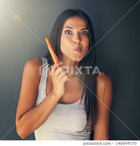 Portrait, woman or eating carrot for healthy food in studio for vegan diet, meal or vegetables for lunch. Grey background, snack or vegetarian person with fresh, natural vitamins or organic produce Portrait, woman or eating carrot for healthy food in studio for vegan diet, meal or vegetables for lunch. Grey background, snack or vegetarian person with fresh, natural vitamins or organic produce 140644370