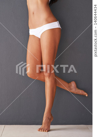 Skincare, wall or legs of woman with underwear for hair removal, epilation or beauty routine results. Model, wellness or person with glow for body grooming, waxing or dermatology on gray background 140644434