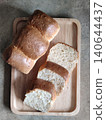 Freshly Sliced White Bread Loaf Pieces Arranged in Wooden Tray for Breakfast, Bakery Serving, or Homemade Meal Preparation 140644437