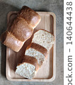 Freshly Sliced White Bread Loaf Pieces Arranged in Wooden Tray for Breakfast, Bakery Serving, or Homemade Meal Preparation 140644438