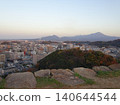 A panoramic view of Mt. Daisen, the highest peak in the Chugoku region, and the city of Yonago, as seen from the castle tower base of Yonago Castle ruins. 140644544