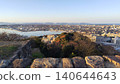 A breathtaking panoramic view of Lake Nakaumi and the city of Yonago at sunset, seen from the stone foundation of the castle tower at the site of Yonago Castle. 140644643