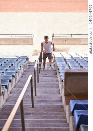 Stairs, running and man with training, exercise and cardio with wellness and healthy with sunshine. Person, runner and athlete with steps and summer with hobby and fitness with practice with energy 140644761