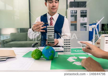 Two colleagues discussing data sustainable development with renewable energy solutions, ecology concept, green business. 140644796