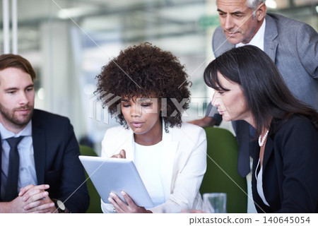 Group, tablet and business people in meeting, planning and brainstorming strategy in office. Collaboration, technology and diverse professional team, CEO and serious consultants in discussion online 140645054