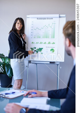Businesswoman, presentation and conference room with charts for analytics report or growth, development or graphs. Female person, colleagues and company strategy or finance sales, meeting or teamwork 140645307