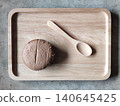 Whole Wheat Bread Served on Wooden Tray with Spoon in Minimal Loft Style Cafe Setting Rustic Bakery  140645425