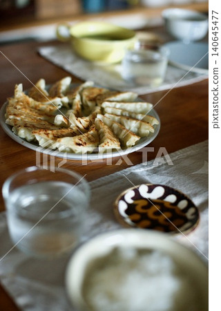 Pan-fried dumplings arranged in a circle on a plate Pan-fried dumplings arranged in a circle on a plate 140645477