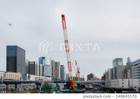 Cranes at a redevelopment site and passenger planes flying over Tokyo. Cranes at a redevelopment site and passenger planes flying over Tokyo. 140645570