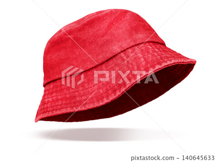 A red denim bucket hat is floating against a white background. A red denim bucket hat is floating against a white background. 140645633