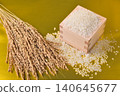 A masu (wooden measuring cup) with a golden background, overflowing with rice and rice stalks. 140645677