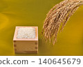 A masu (wooden measuring cup) with a golden background, overflowing with rice and rice stalks. 140645679