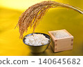 Rice served in a wooden box with a gold background, rice in a bowl, and rice stalks. 140645682