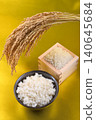 Rice served in a wooden box with a gold background, rice in a bowl, and rice stalks. 140645684