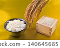 Rice served in a wooden box with a gold background, rice in a bowl, and rice stalks. 140645685